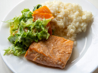Baked salmon with rice and salad. A healthy meal that is easy and quick to prepare. Delicious...