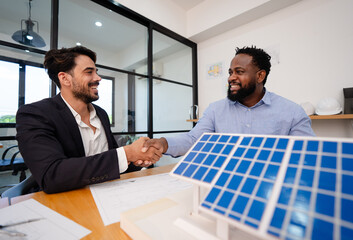 team of coworker shaking hand for successful solar roof system project with house model,...