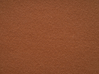 A rustic canvas of terracotta, this felt surface exudes an earthy warmth, akin to a sun-baked clay...