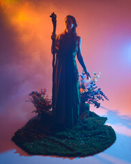 Dramatic portrait of female model figure wearing green fantasy fae cloak costume.
Colourful backlit...