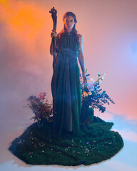 Dramatic portrait of female model figure wearing green fantasy fae cloak costume.
Colourful backlit...