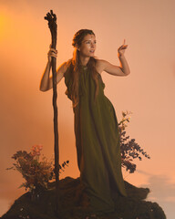 Dramatic portrait of female model figure wearing green fantasy fae cloak costume.
Colourful backlit...