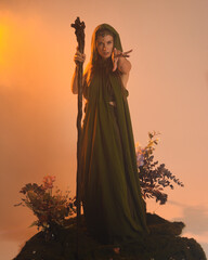 Dramatic portrait of female model figure wearing green fantasy fae cloak costume.
Colourful backlit...