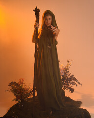 Dramatic portrait of female model figure wearing green fantasy fae cloak costume.
Colourful backlit...