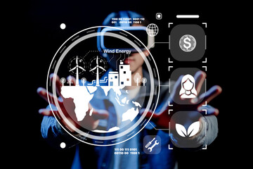 Futuristic Interface Displaying Wind Energy Concepts with Person Interacting in Dark Background, Innovative Technology and Sustainable Development Theme