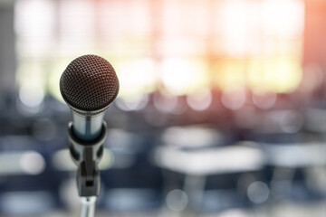 Microphone voice speaker in seminar classroom, lecture hall, town hall meeting or conference forum in educational business event for coaching host or teacher with audiences or students seats