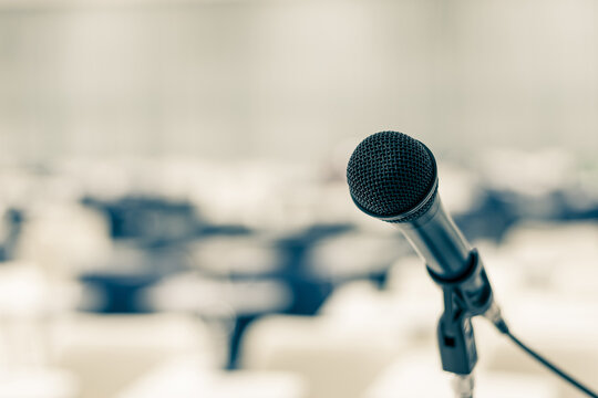 Microphone voice speaker in seminar classroom, lecture hall, town hall meeting or conference forum in educational business event for coaching host or teacher with audiences or students seats