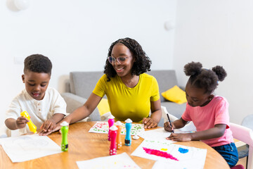 Mother and children painting together at home