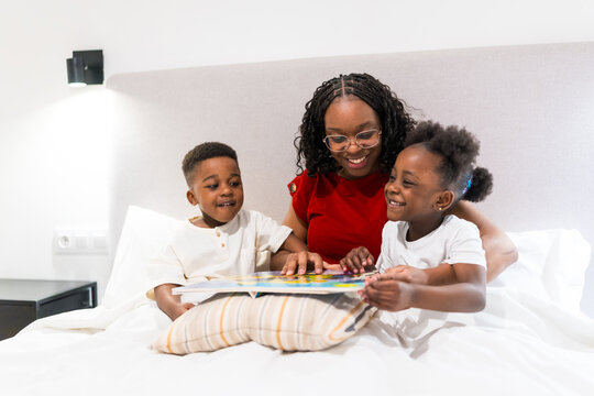 Mother reading a bedtime story to her children