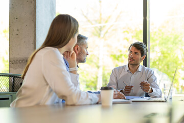 Group of happy progressive business people working on startup together at creative office
