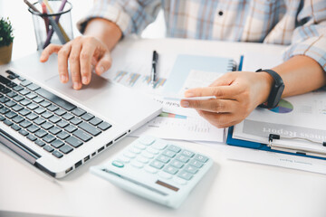 Woman calculating monthly home expenses, taxes, bank account balance and credit card bills payment,...