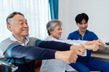 senior man practices muscle strength exercises arms and hands instruct by physiotherapist. home...