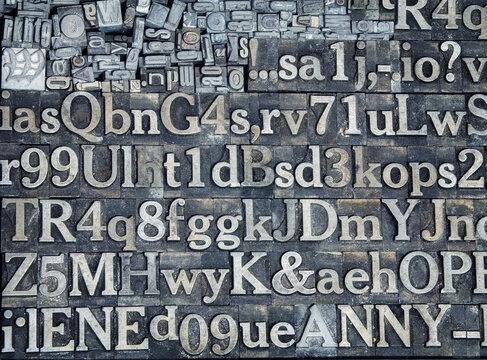 Vintage letterpress printing blocks with letters, numbers, and symbols.