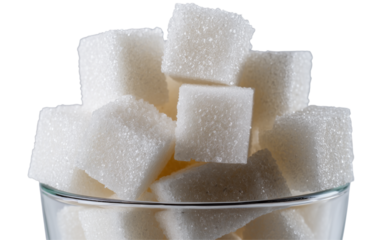 A clear glass bowl filled with white sugar cubes isolated on transparent background. PNG, cutout. 
