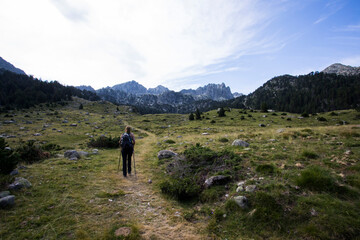 Obraz premium Young hiker woman in Vall de Boi, Aiguestortes and Sant Maurici National Park, Spain