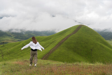 Lifestyle traveler women raise hand feeling good relax and happy freedom   in the sunrise morning....