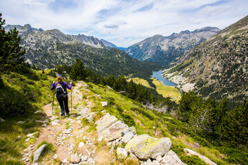Fototapeta premium Young hiker woman in Vall de Boi, Aiguestortes and Sant Maurici National Park, Spain