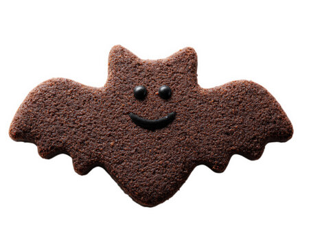 Bat shaped chocolate cookie isolated on transparency background features smiling face fun and playful design perfect for Halloween dessert snack or party decoration