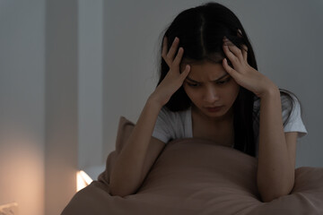 asian woman in bed late trying to sleep suffering insomnia, sleepless or scared in a nightmare,...