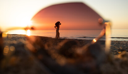 silhouette of girl at the seaside viewed through sunglasses