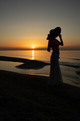 Fototapeta premium silhouette of a girl at sunset over the Baltic Sea