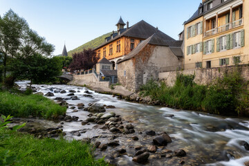 The Neste du Louron river flowing through the town of Arreau in the foothills of the Pyrenees mountains in France