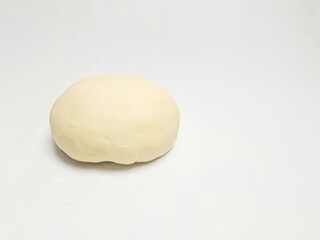 Raw dough ball on a white background, perfect for baking preparation, food blog visuals, or culinary stock images
