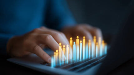 Hands typing on laptop with dynamic demographic analytics chart