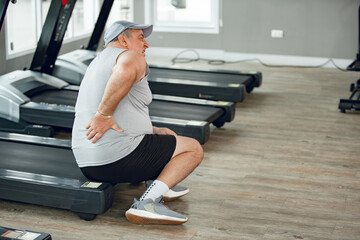 Man with low back pain in gym. Sports exercising injury. healthcare and lifestyle concept