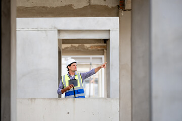 Engineer builder. Foreman work in construction site. Construction site manager standing wearing...