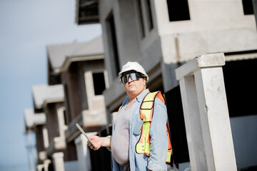 Engineer builder. Foreman work in construction site. Construction site manager standing wearing...