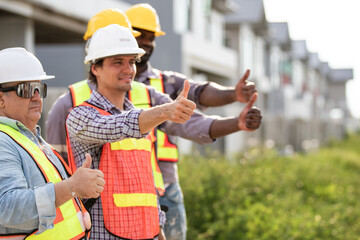 Construction workers and civil engineer showing thumbs up. Success Team of foreman and worker...