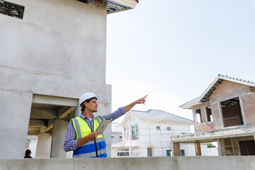 engineers in safety gear inspecting a building under construction