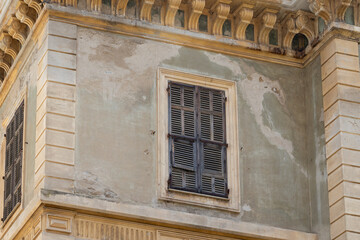 Old weathered window with wooden shutters on historic building France, Corsica, Ajaccio, 13 June...