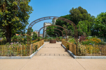 Central path in garden with symmetrical flower beds and arches France, Corsica, Ajaccio, 13 June 2025
