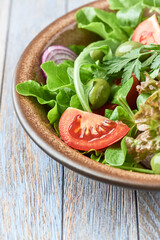 Healthy and tasty salad with tomatoes, olives, cucumber and lettuce.