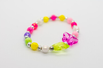 Colorful bracelet with a butterfly charm. The bracelet is made of beads and has a shiny silver...