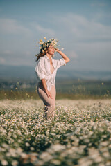 Daisies Woman Summer: Lady relaxes in chamomile field wearing floral crown during sunny day.