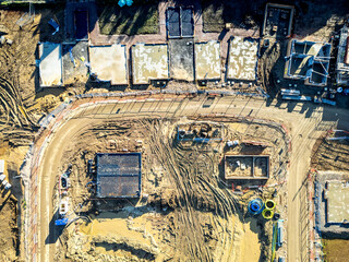 UAV top down view of groundworks seen being completed for a housing project in the UK. Concrete...