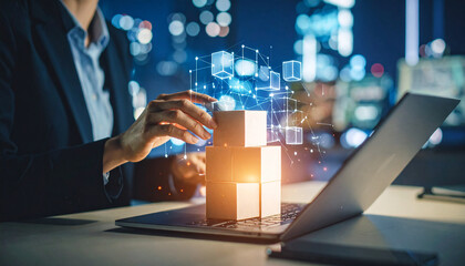 Businesswoman interacts with digital blocks above a laptop, set against a blurred cityscape.