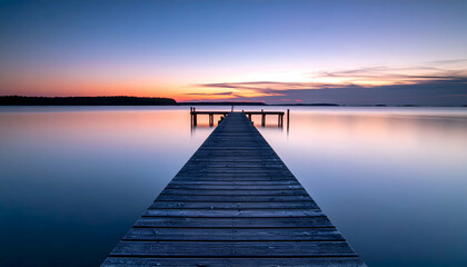 Obraz premium Peaceful Wooden Pier Extending Into Calm Lake Water at Colorful Sunset with Serene Horizon
