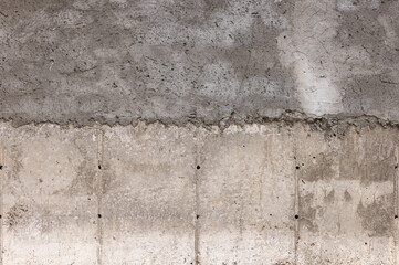 Rough textured concrete wall outdoors in daylight