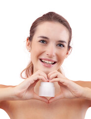 Smiling young woman with makeup holding a plastic cosmetic jar of face cream while make a heart...