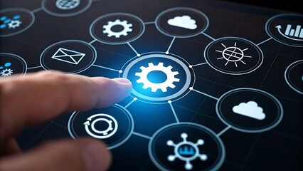 Finger touching a glowing gear icon on a digital interface connecting various technology symbols