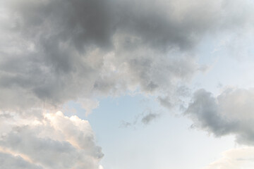 abstract background of fluffy clouds on a bright blue sky before sunset golden hour