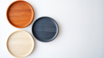 Elegant wooden trays three colors orange, beige, and dark gray, arranged light background, showcasing their smooth textures and natural beauty