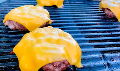 Burger patties are grilled with cheese