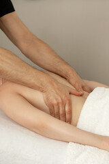 Close-up of the masseur's hands. Lower back massage, back massage. Prevention and treatment