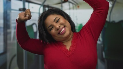 Woman in red sweater stretches on bus, expressing relaxation and comfort during a peaceful journey, showcasing a joyful and serene moment. - Powered by Adobe
