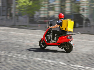 Abstract image of a courier on a motorcycle on a blurred background © Halytskyi Olexandr